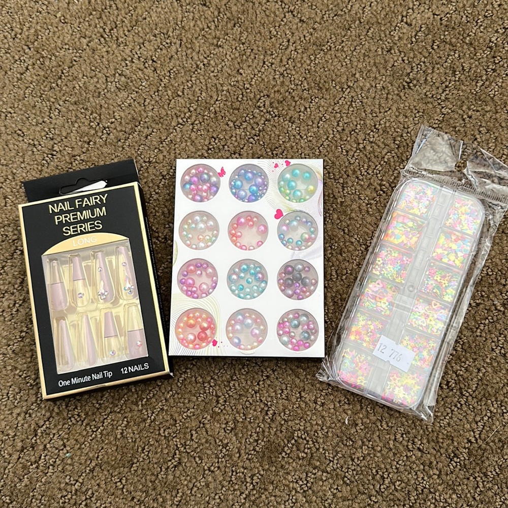 Long press on nails with nail charms.